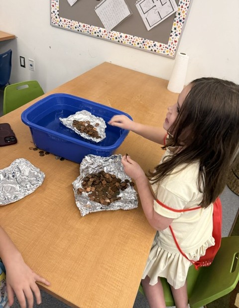 Students work at making aluminum foil boats. Photos source: Elizabeth Costa
