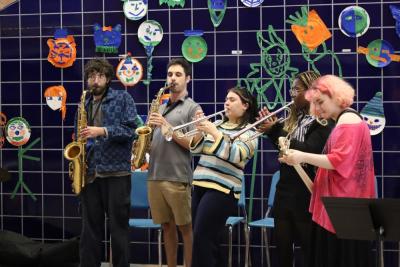 Wareham alumna Sophia Maniglia, center, performs with other students and music teacher Jason Roth, to her left. Photos by Nick Mossman