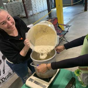 A chef from Pit's Pub pours chowder into the crockpot. 