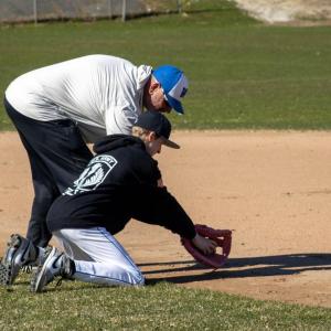 Coach Cabe works with his players on low catches.