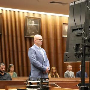 Selectman Jared Chadwick stands in a courtroom on Thursday, July 9, before separate charges from earlier this year were dismissed. Photo by Nick Mossman